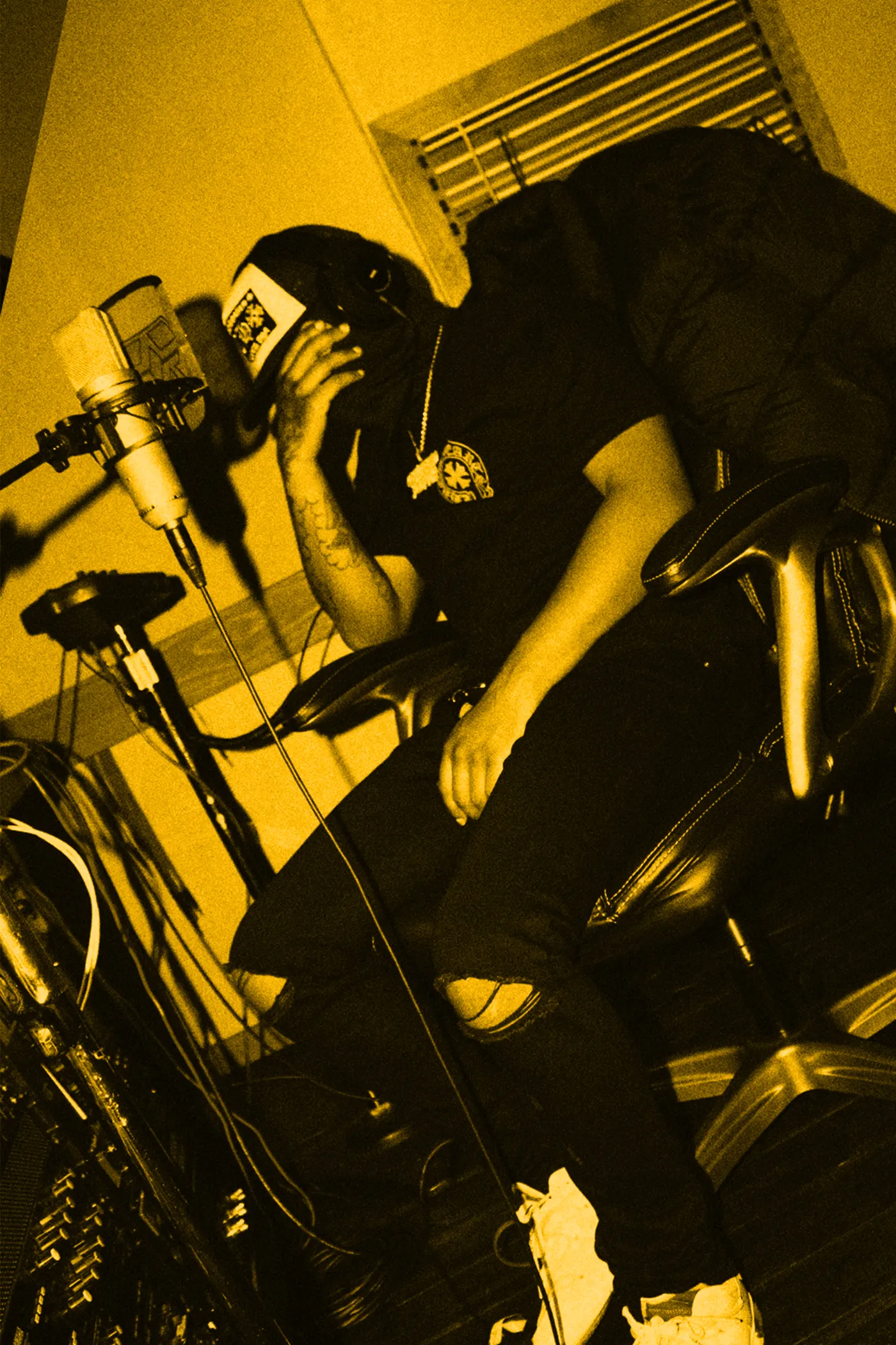 An artist leaning back at the microphone